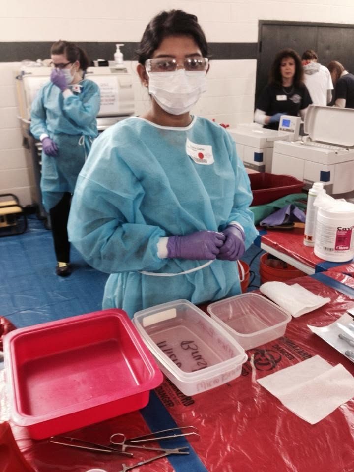 Zobia Zafar, PA-C, preparing instruments at a Remote Area Medical clinic