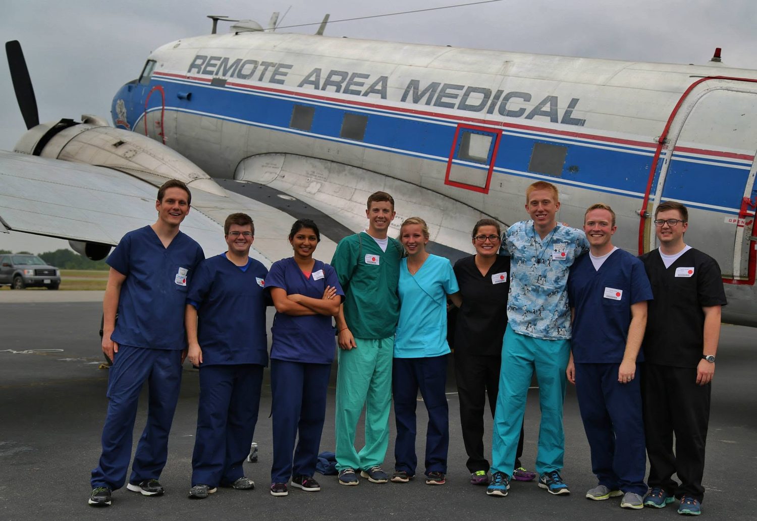 Zobia Zafar, PA-C, with the Remote Area Medical volunteer crew beside the clinic DC-3 aircraft
